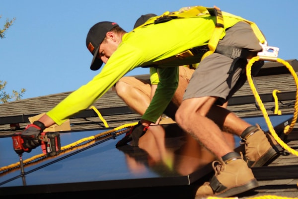Electrician on ladder performing emergency electrical repair