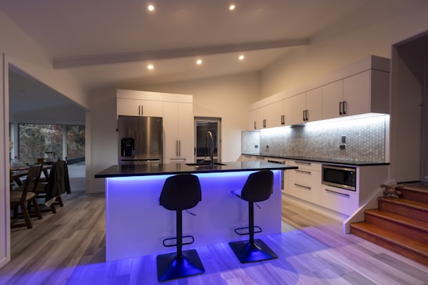 Modern kitchen with LED strip lighting and recessed ceiling lights